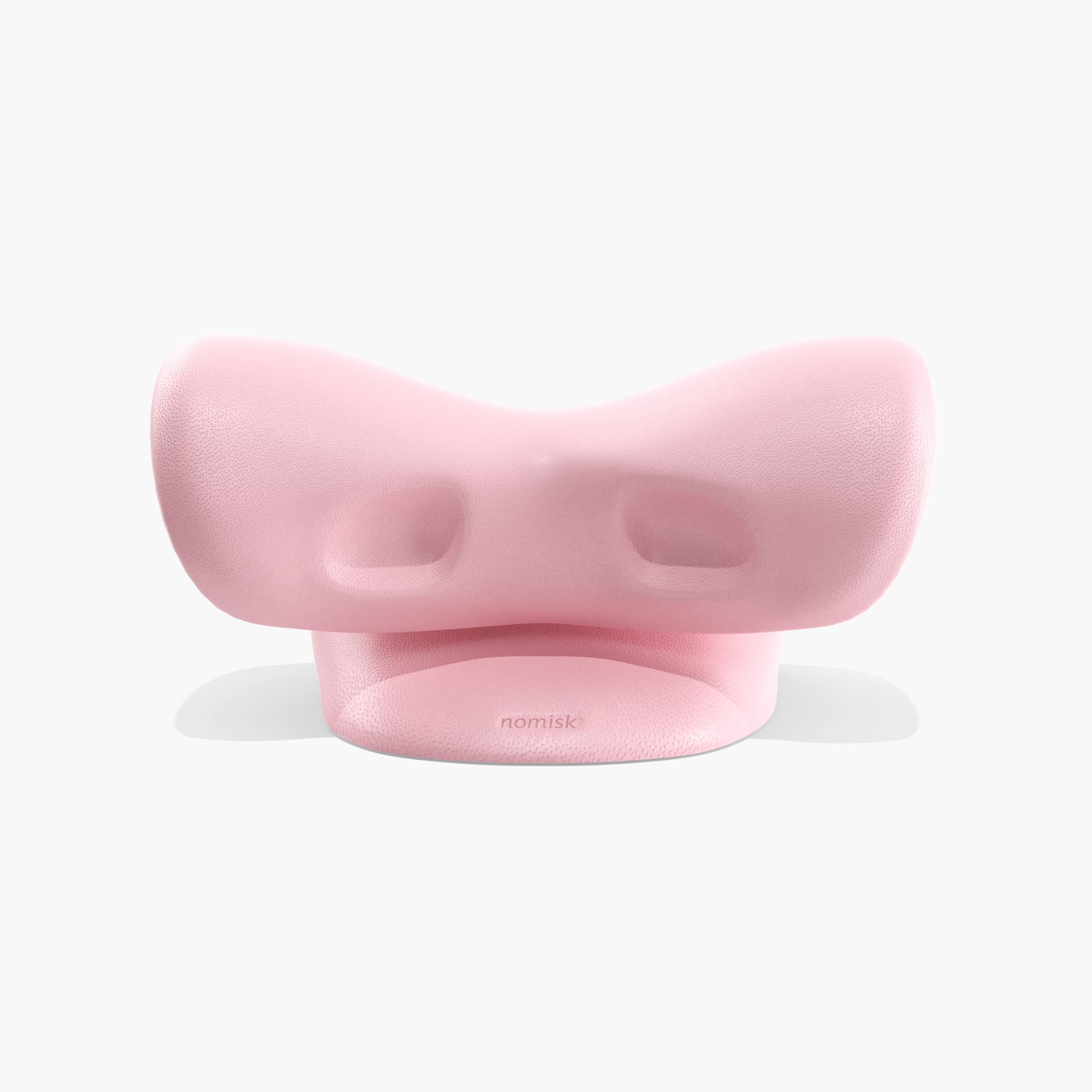 Juno by Nomisk. A pink cervical traction pillow that instantly relieves neck pain. Relieve tension, improve sleep, posture and blood flow by using Juno to stretch out your neck. Shown here from a rear view.